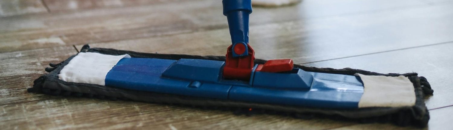 Mop cleaning a wooden floor, showcasing professional cleaning tools for residential and commercial services in Newnan, Georgia.